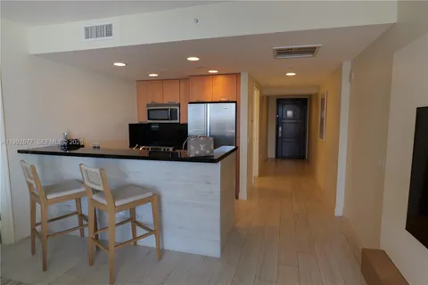 a kitchen with a sink and a refrigerator
