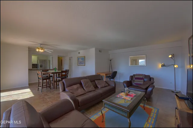 a living room with furniture a table and a window