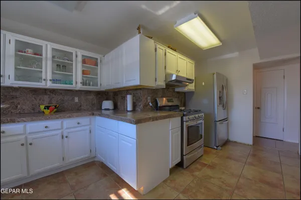 a view of a hallway with a kitchen
