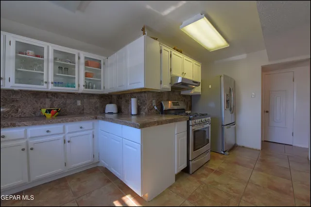 a view of a hallway with a kitchen
