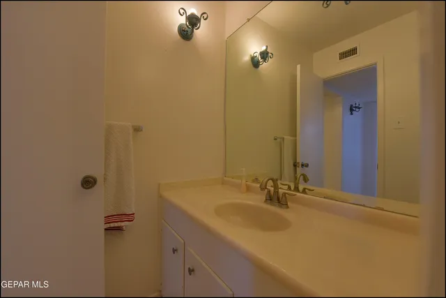 a view of a workspace with furniture and a fan