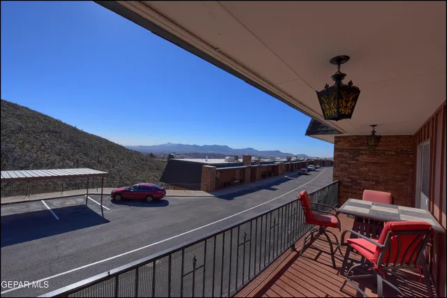 a view of a balcony with chairs