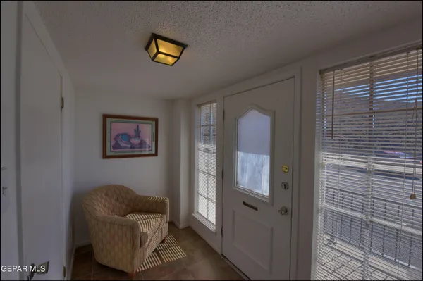 a balcony with couch and a potted plant