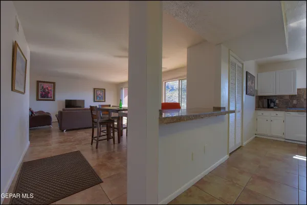 a living room with furniture and a kitchen