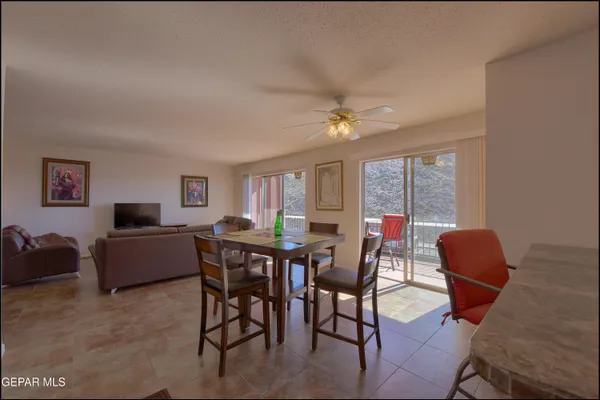 a dining room with furniture a rug and a large window