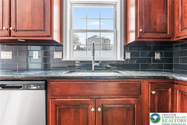 a kitchen with granite countertop a sink and a window