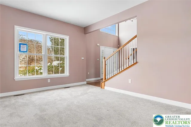 a view of staircase with wooden floor and white walls