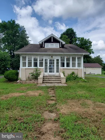 a view of a house with yard and a garden