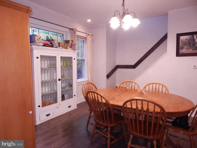 a view of a dining room with furniture wooden floor and chandelier