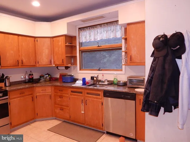 a kitchen with a sink window and cabinets