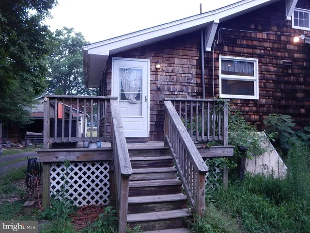 a front view of a house with wooden stairs