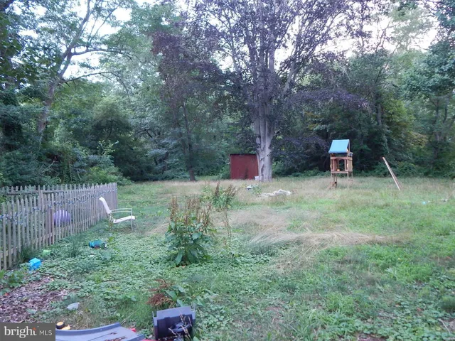 a view of a chairs and table in the back yard
