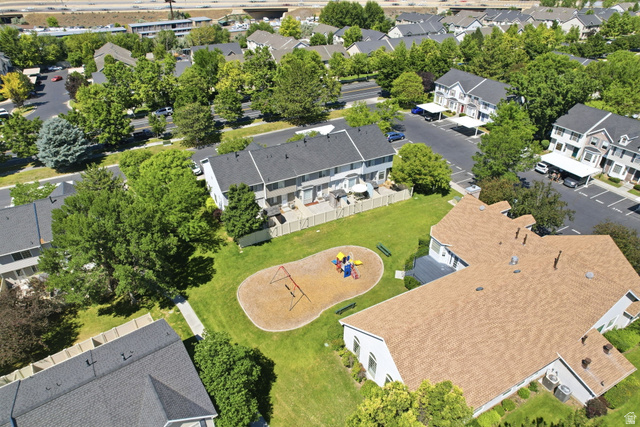 984 Independence Avenue Provo, UT 84604 - Photo 14 of 19 Expansive green space featuring a playground with swing set and slide, surrounded by a manicured lawn and mature trees