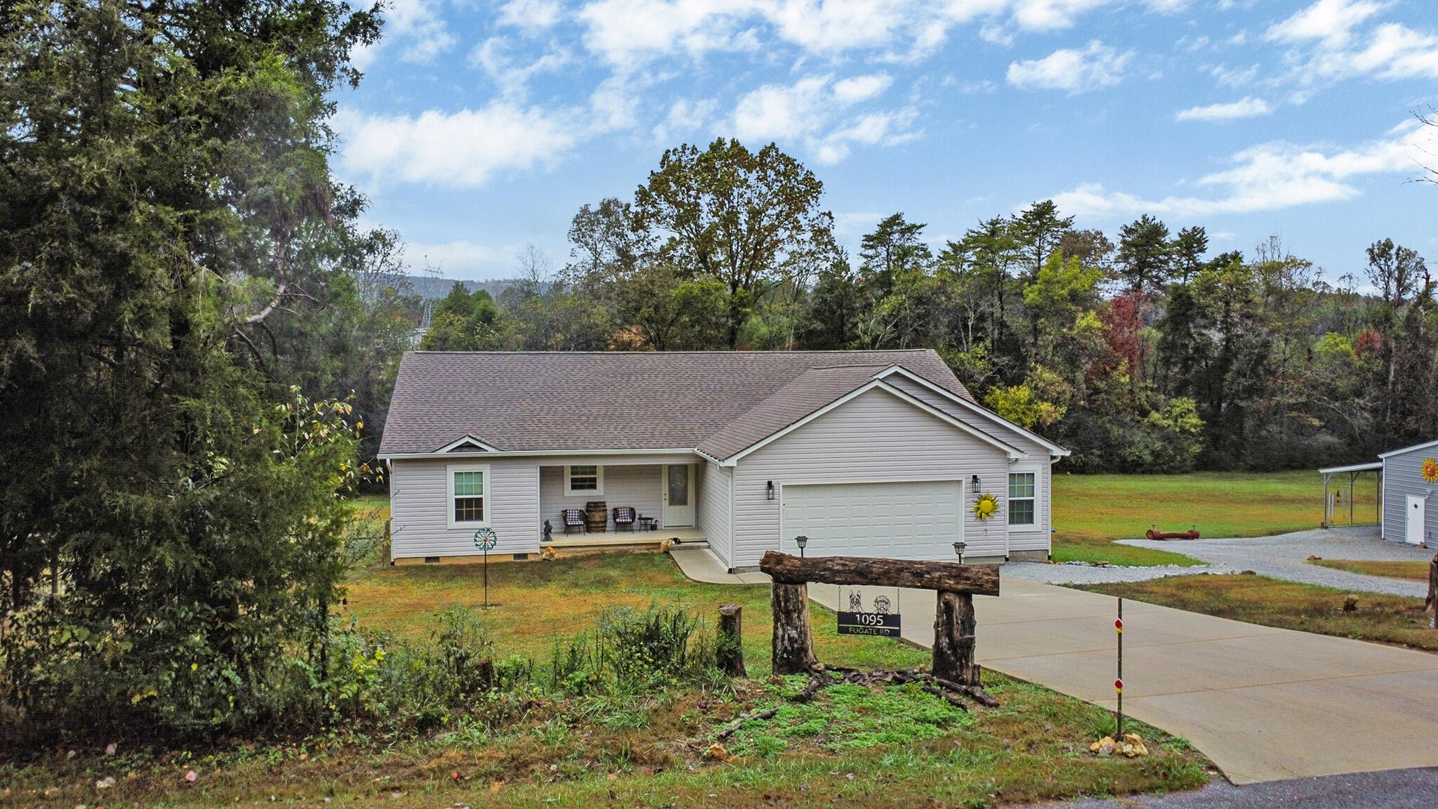 a view of a house with a yard and sitting area