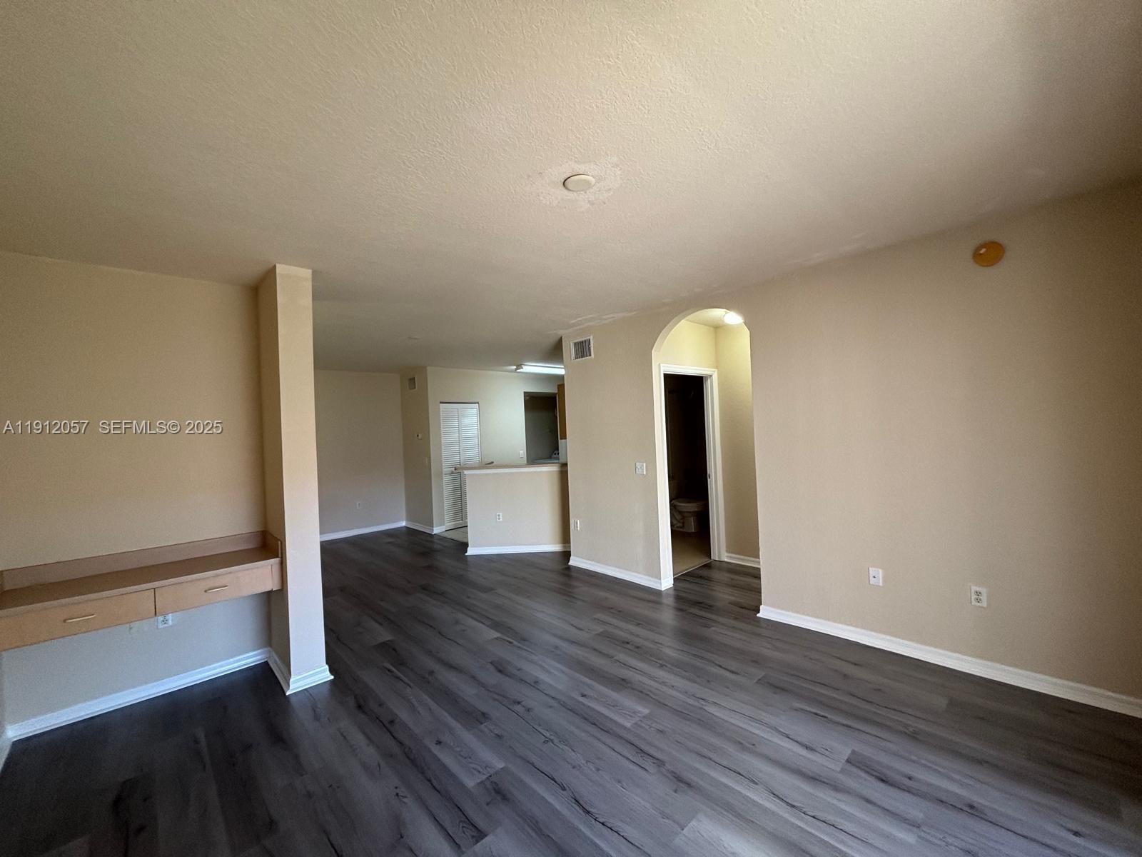 8261 Southwest 25th Court, Unit 102 Miramar, FL 33025 - Photo 8 of 15 a view of empty room with wooden floor