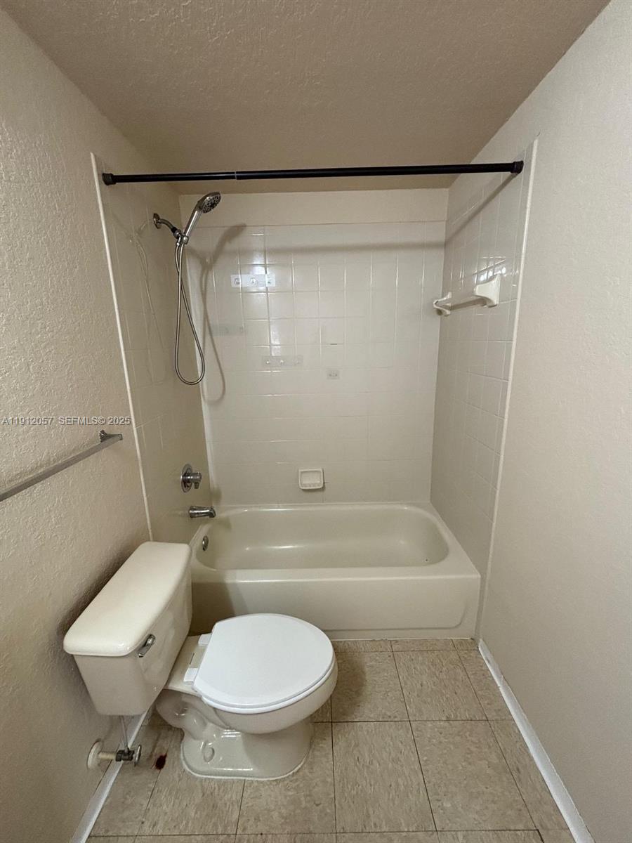 8261 Southwest 25th Court, Unit 102 Miramar, FL 33025 - Photo 10 of 15 a bathroom with a toilet and a shower