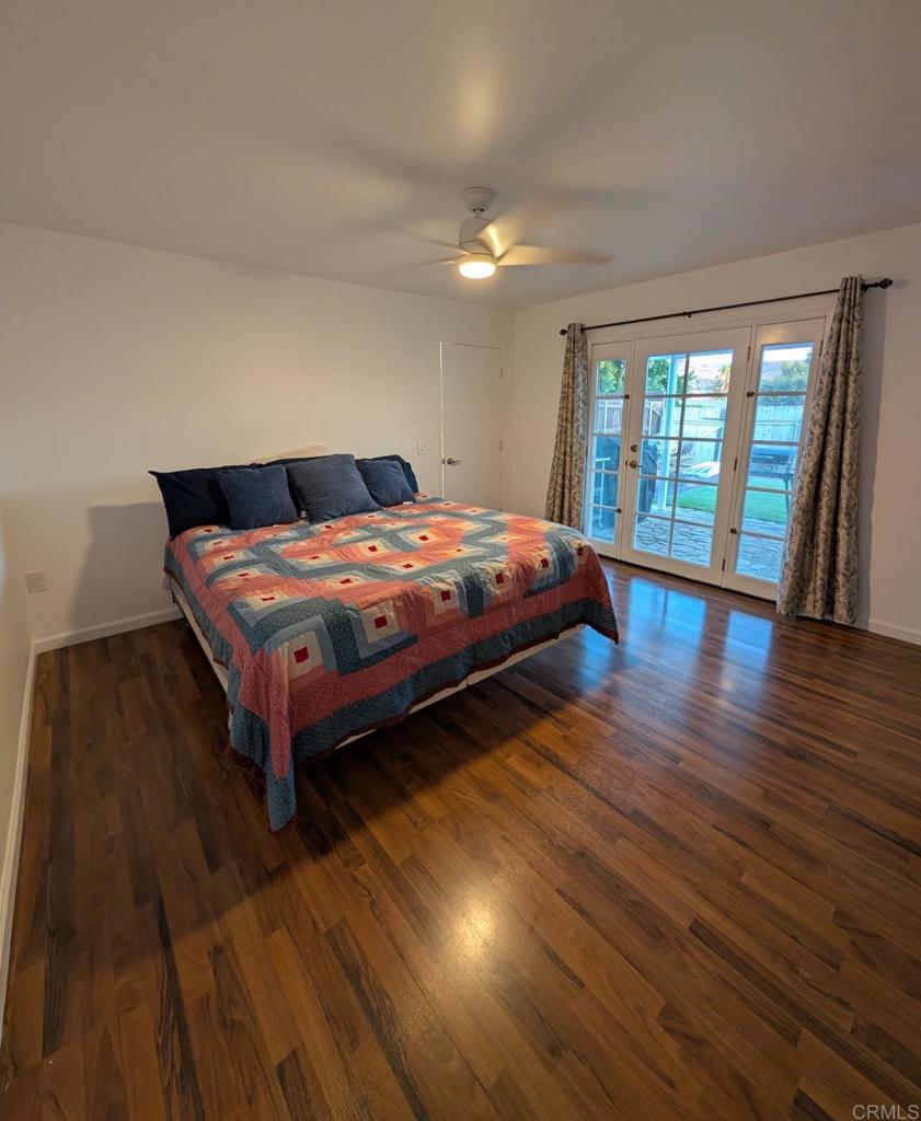 14417 Springvale Street Poway, CA 92064 - Photo 6 of 14 a bedroom with a bed and wooden floor