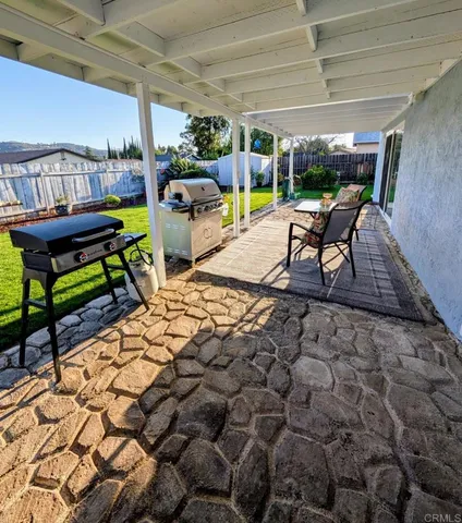 a view of a chairs and table in patio