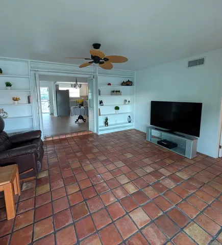 a room with natural light and flat screen tv