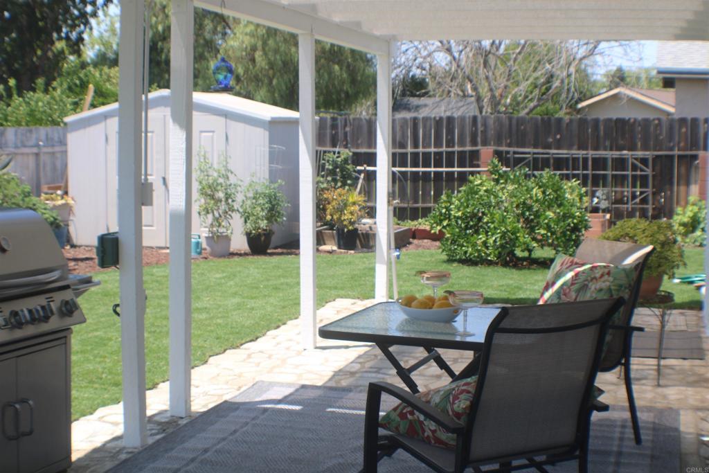 14417 Springvale Street Poway, CA 92064 - Photo 10 of 14 a view of a patio with a table chairs and a garden