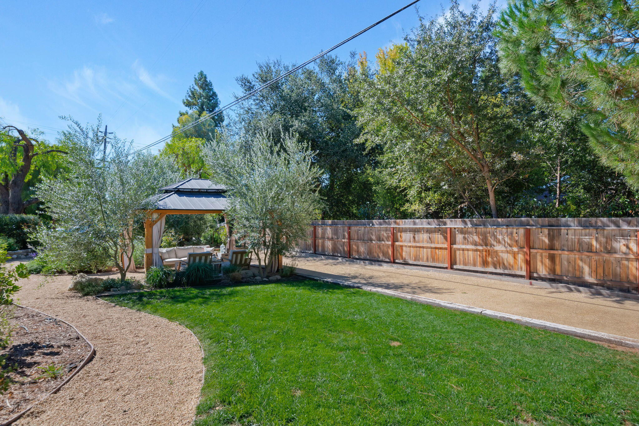 2455 Lucca Avenue Los Olivos, CA 93441 - Photo 23 of 37 a view of a backyard with a garden and trees