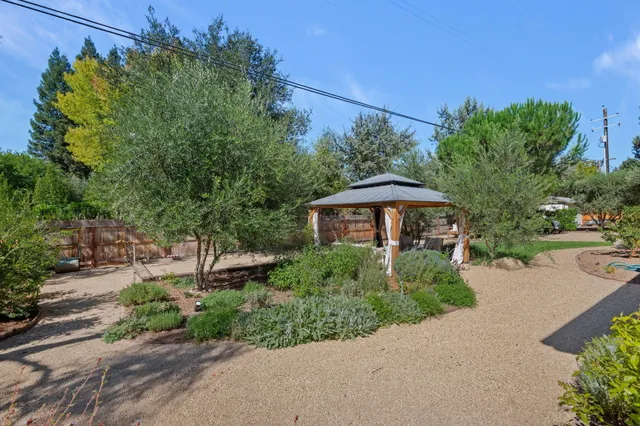 a patio with wooden table and chairs