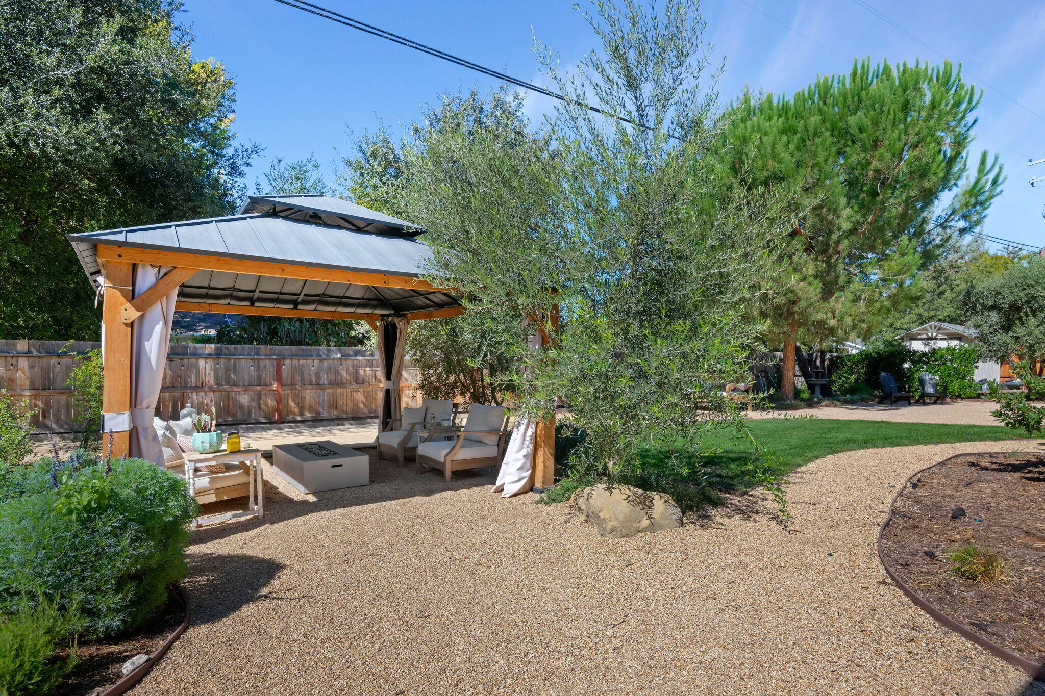 2455 Lucca Avenue Los Olivos, CA 93441 - Photo 29 of 37 a patio with wooden table and chairs