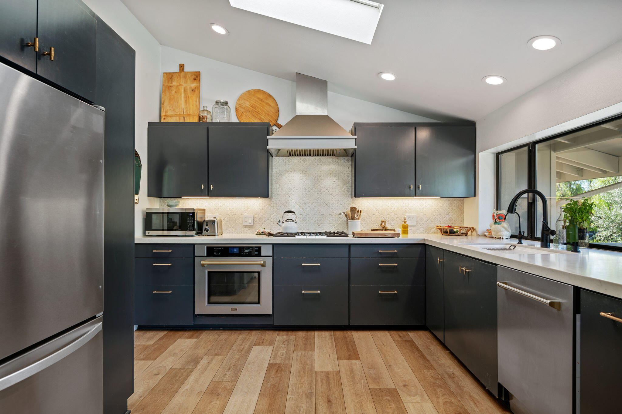 2455 Lucca Avenue Los Olivos, CA 93441 - Photo 3 of 37 a kitchen with stainless steel appliances granite countertop a sink and stove top oven