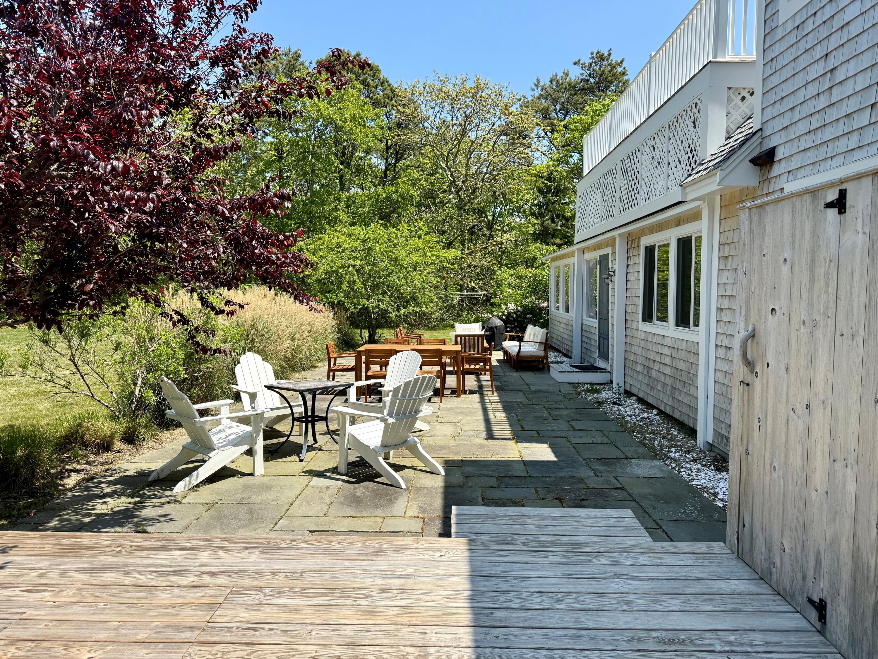 5 Pip'n Road Edgartown, MA 02539 - Photo 11 of 25 a view of a patio with table and chairs with wooden floor and fence