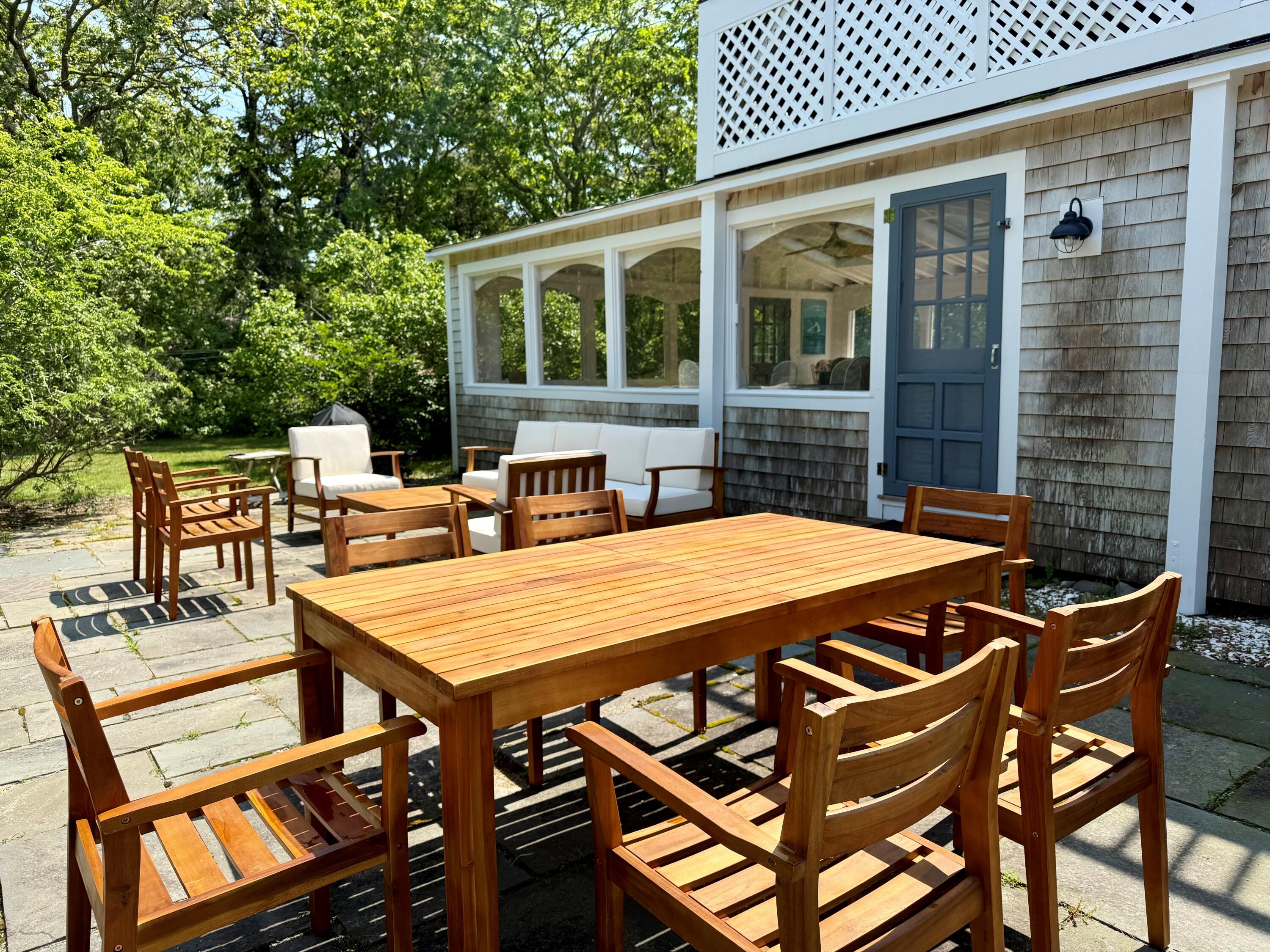5 Pip'n Road Edgartown, MA 02539 - Photo 10 of 25 a view of a patio with table and chairs with wooden floor and fence