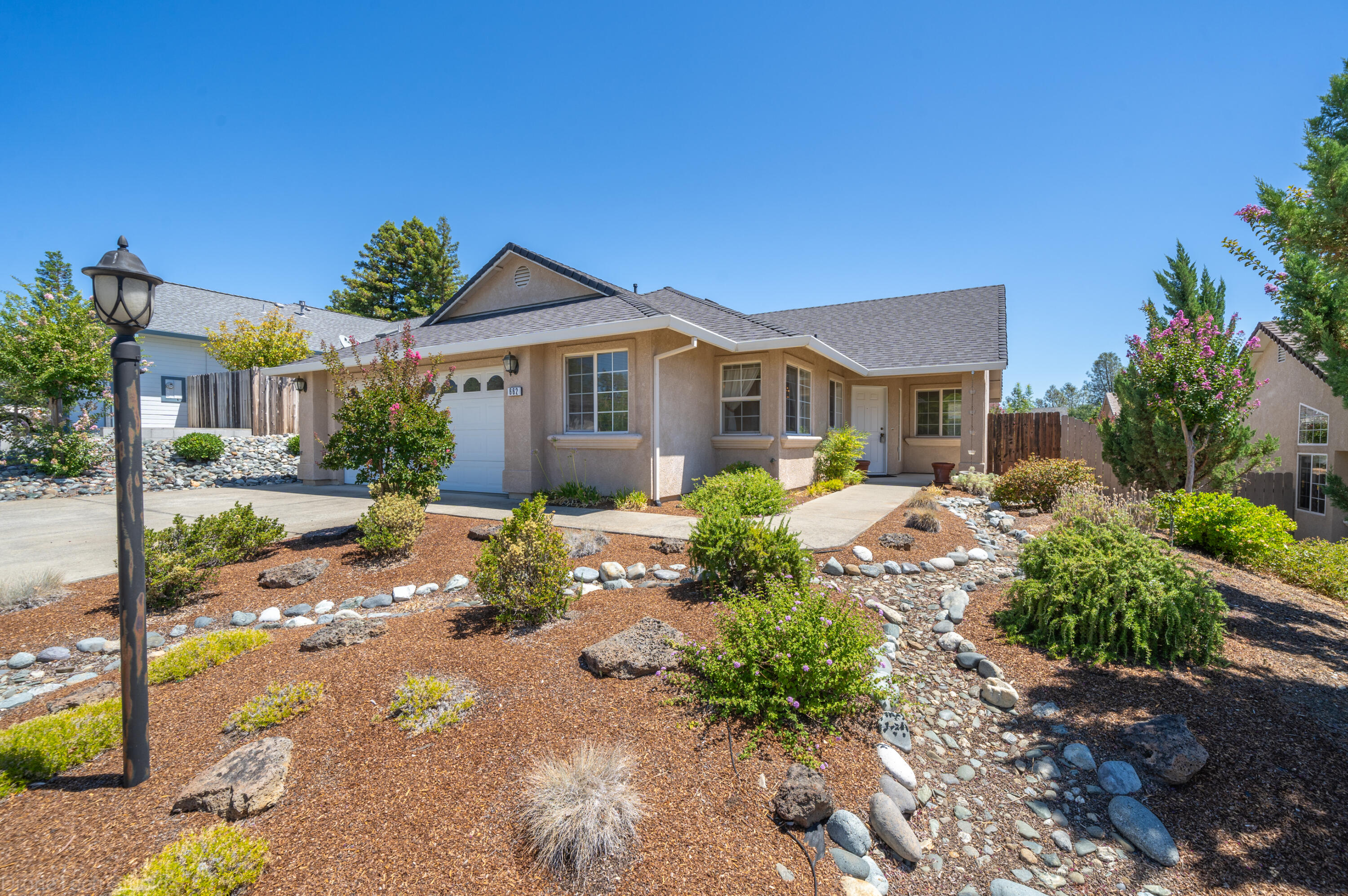 662 Volcano View Trail Redding, CA 96003 - Photo 1 of 26 a front view of a house with a yard