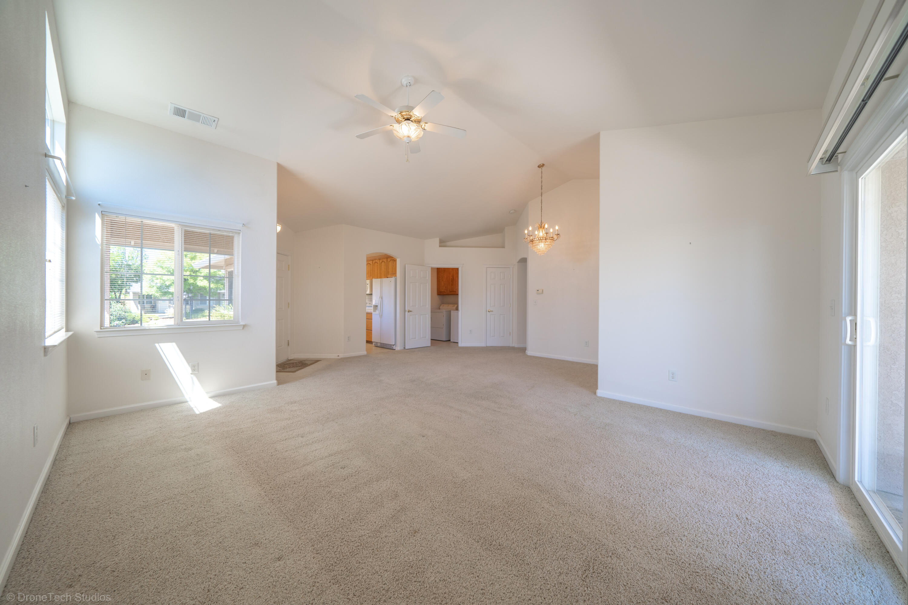662 Volcano View Trail Redding, CA 96003 - Photo 11 of 26 an empty room with windows and chandelier fan