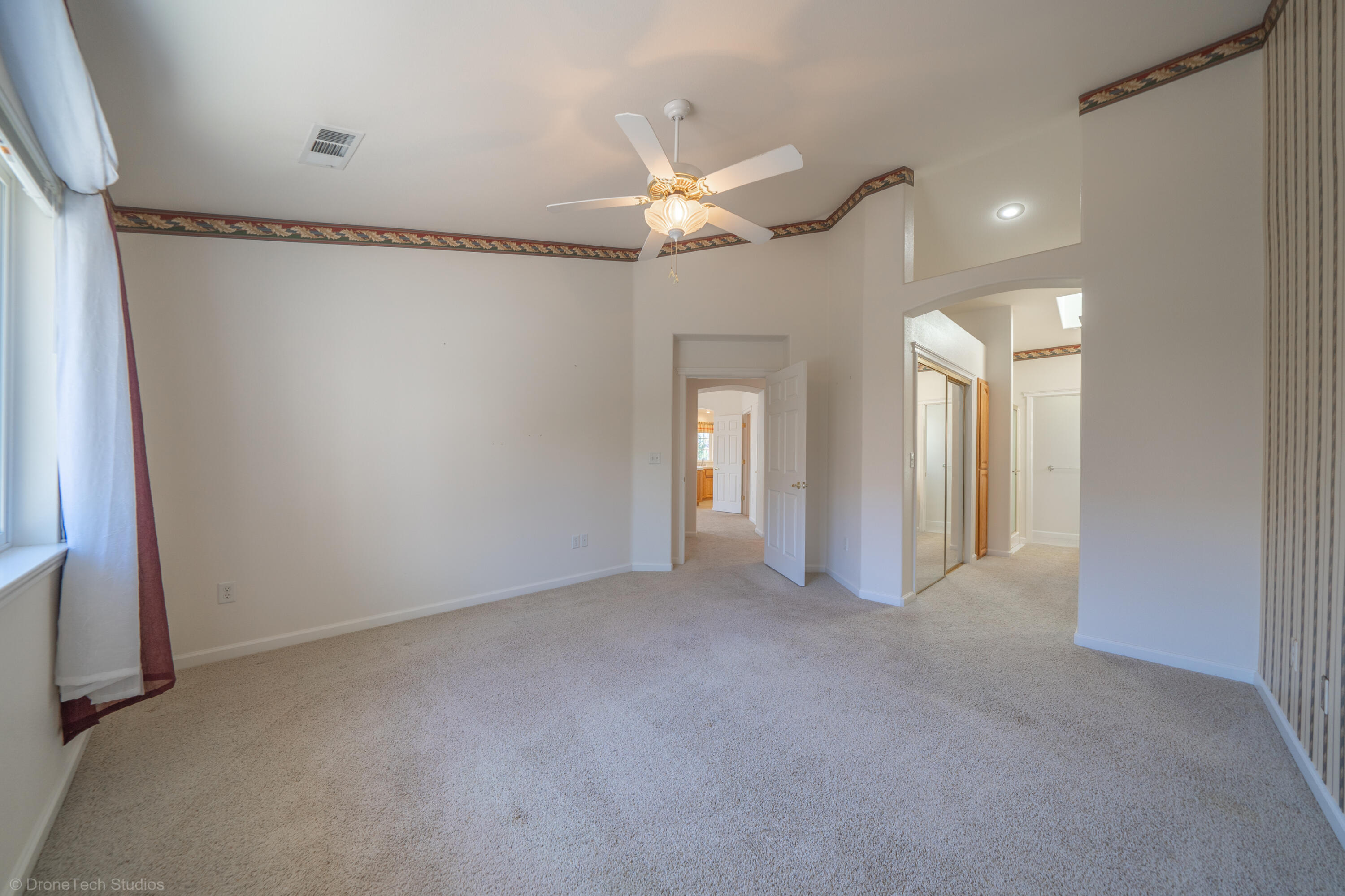 662 Volcano View Trail Redding, CA 96003 - Photo 12 of 26 a view of a livingroom with a ceiling fan and window
