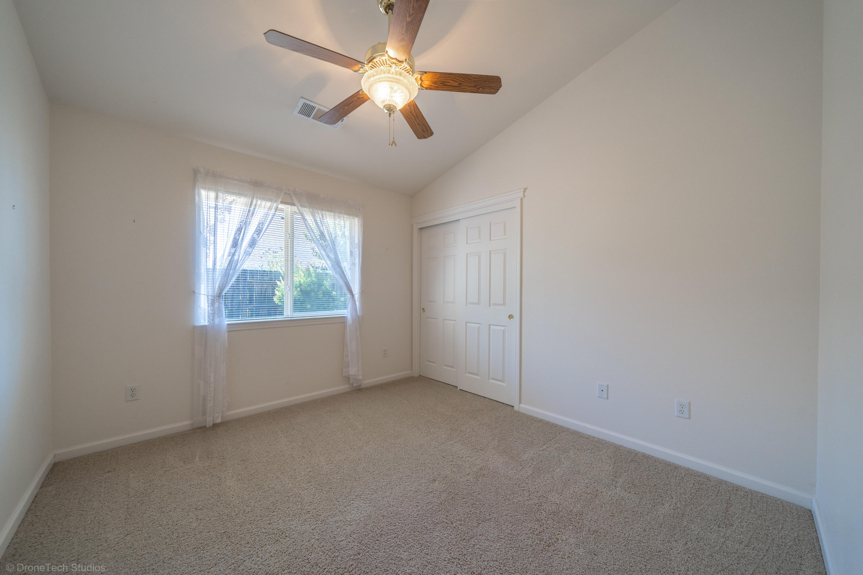 662 Volcano View Trail Redding, CA 96003 - Photo 14 of 26 an empty room with a window and a fan