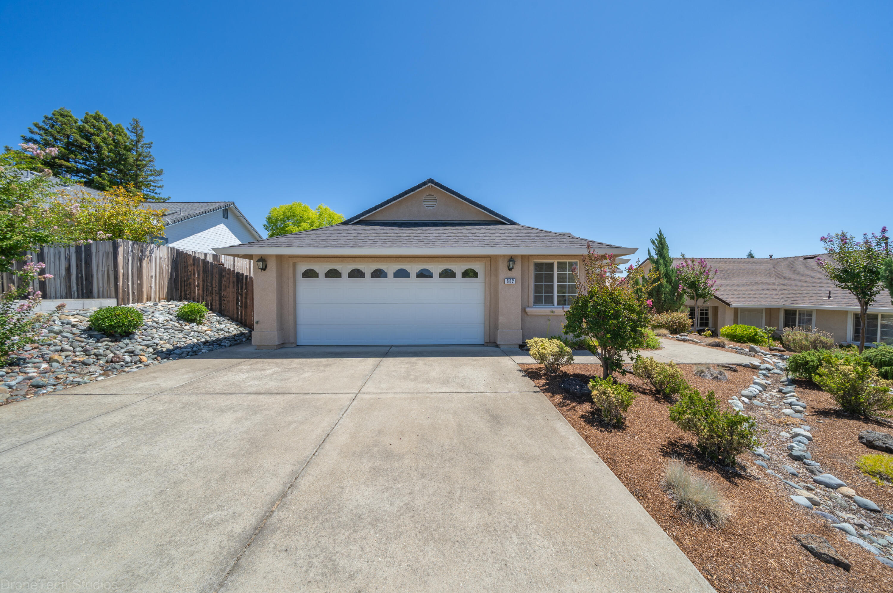 662 Volcano View Trail Redding, CA 96003 - Photo 20 of 26 a front view of a house with a yard and garage