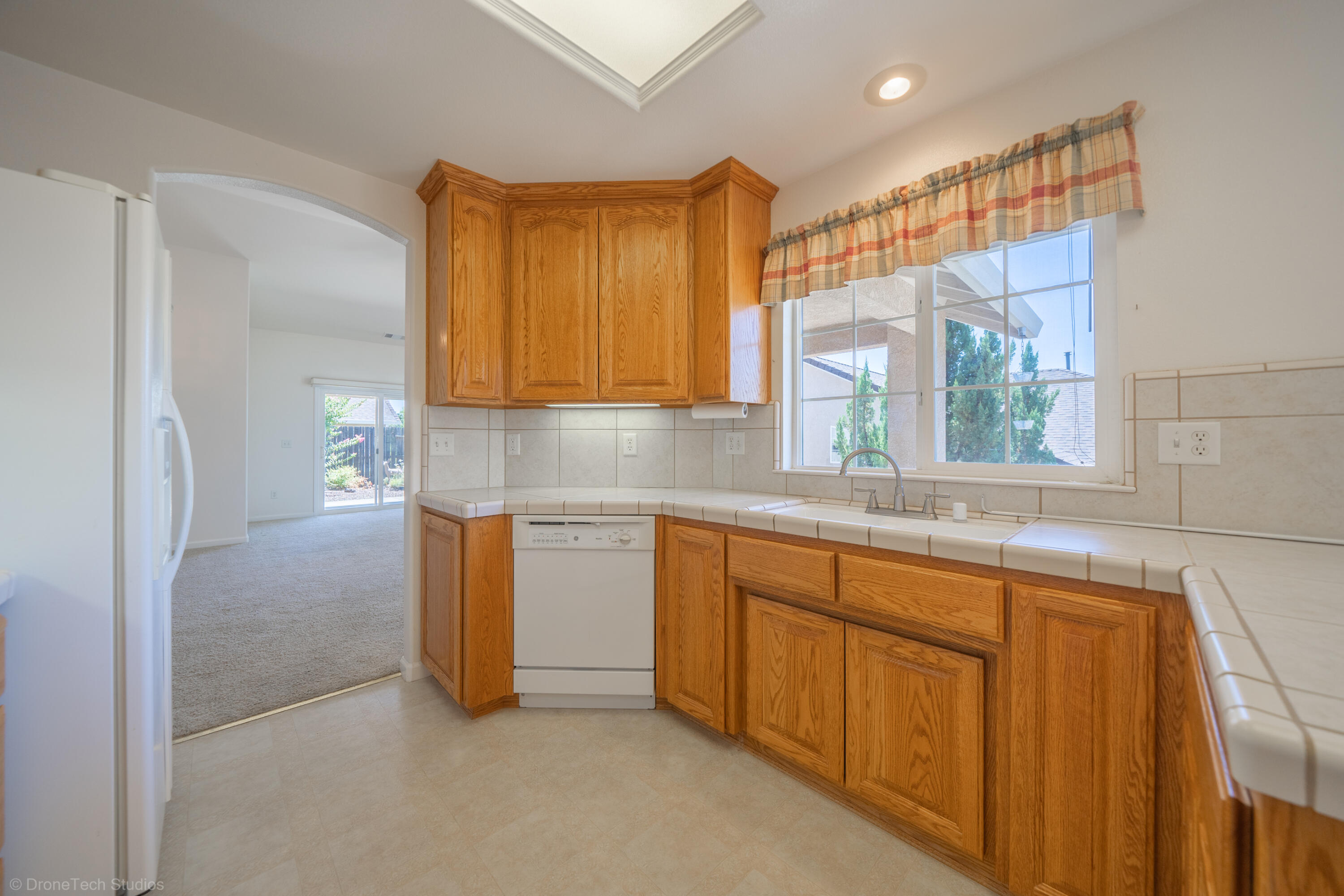 662 Volcano View Trail Redding, CA 96003 - Photo 5 of 26 a kitchen with stainless steel appliances granite countertop a sink and a refrigerator
