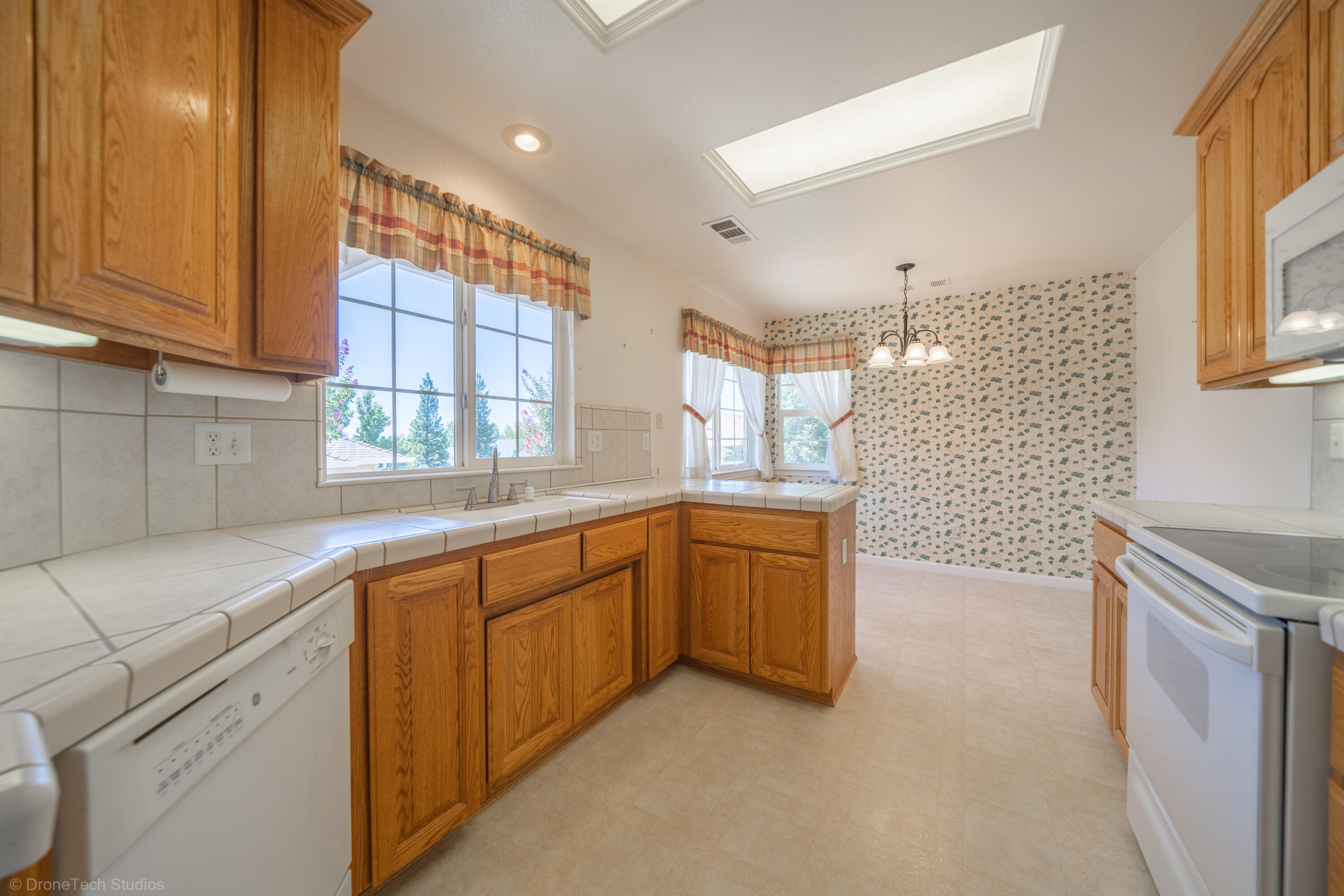 662 Volcano View Trail Redding, CA 96003 - Photo 6 of 26 a large kitchen with stainless steel appliances granite countertop a sink and a stove next to a window