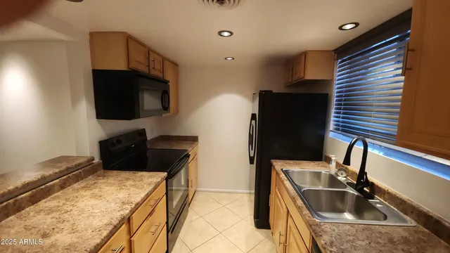 a kitchen with a sink and a refrigerator