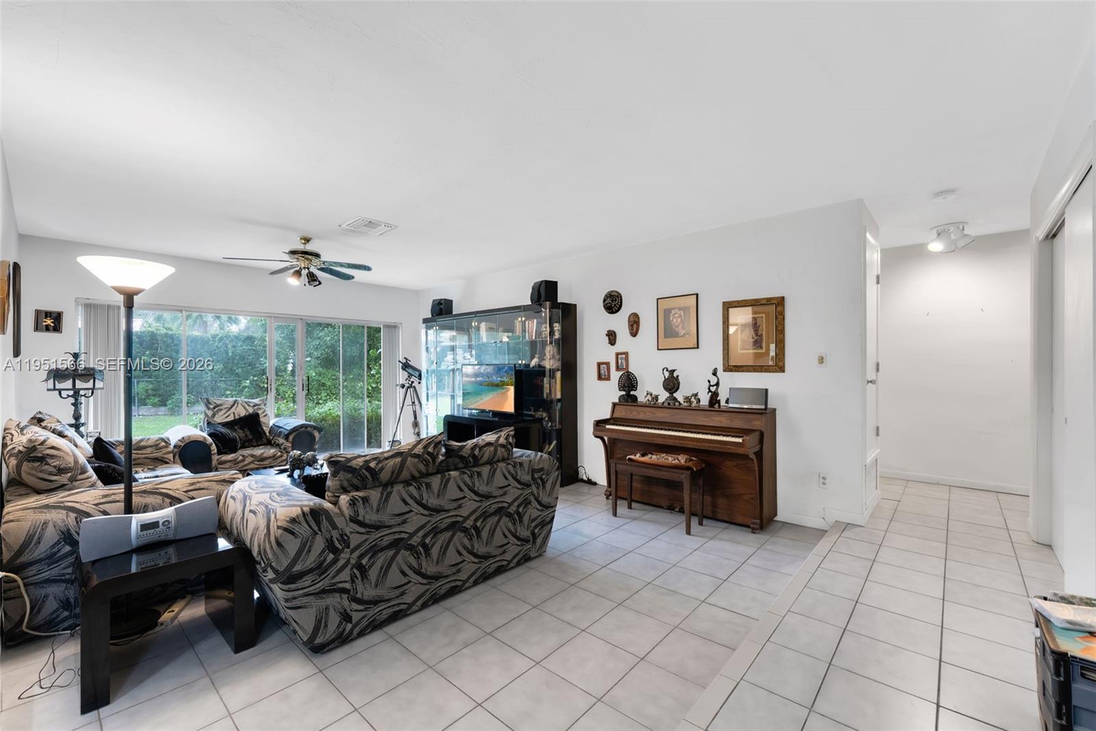 9925 Southwest 97th Place Miami, FL 33176 - Photo 12 of 15 a living room with furniture and a chandelier