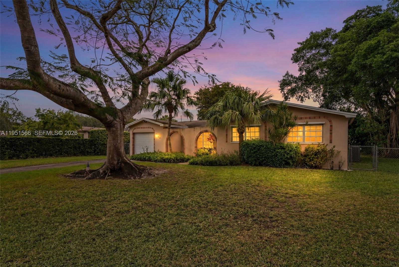 9925 Southwest 97th Place Miami, FL 33176 - Photo 2 of 15 a tall tree in middle of green field