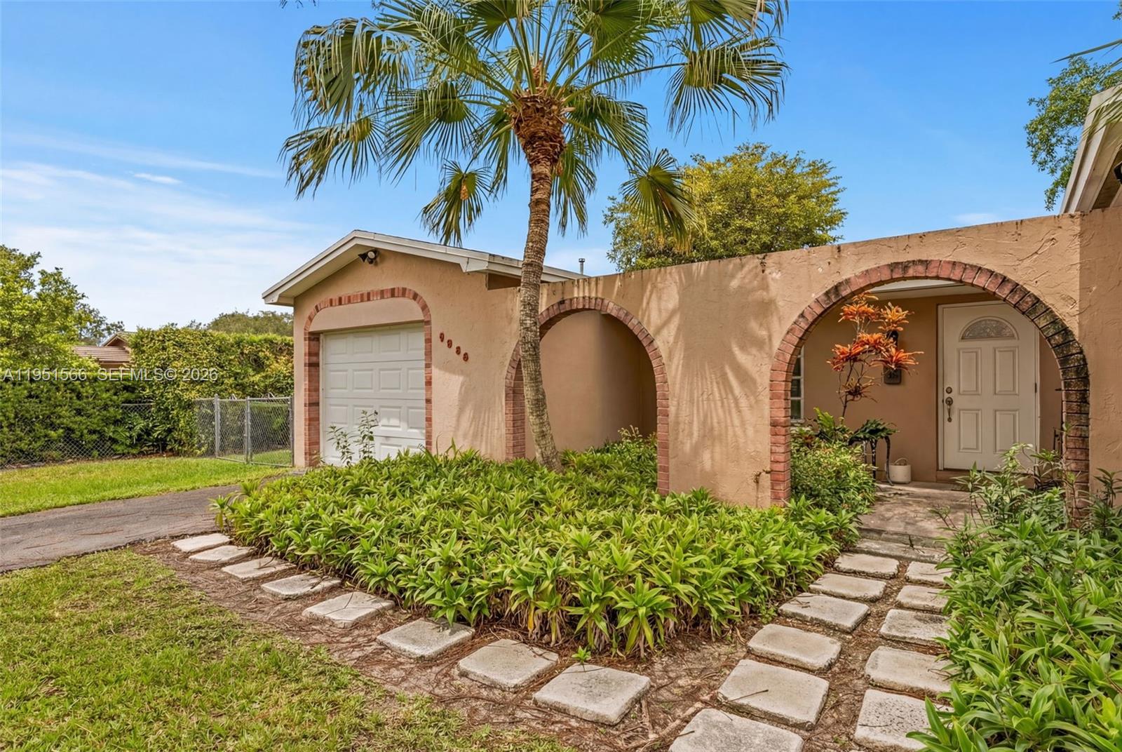 9925 Southwest 97th Place Miami, FL 33176 - Photo 5 of 15 a front view of a house with garden