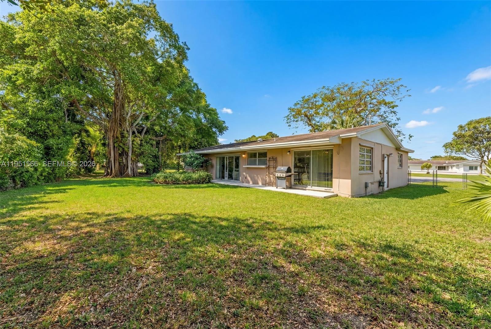 9925 Southwest 97th Place Miami, FL 33176 - Photo 9 of 15 a front view of a house with garden