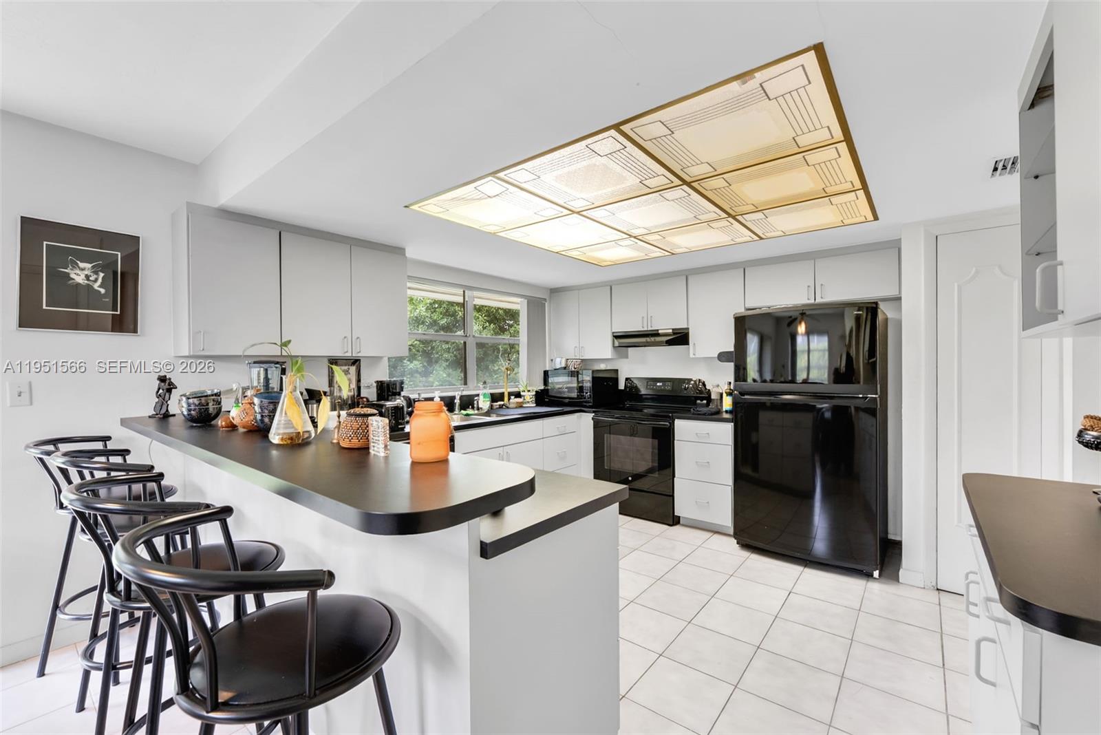 9925 Southwest 97th Place Miami, FL 33176 - Photo 10 of 15 a kitchen with a refrigerator and a stove top oven