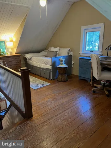 a bedroom with furniture and a window