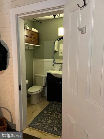 a bathroom with a toilet a sink and mirror