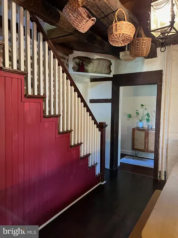a view of entryway and hall with wooden floor