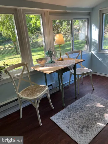 a view of a dining room with furniture and window