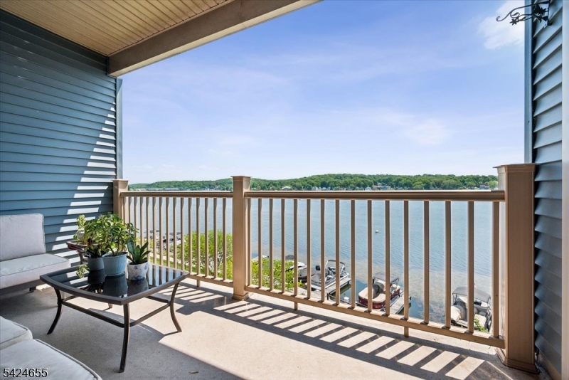 401 Mariners Pointe Hopatcong, NJ 07843 - Photo 20 of 42 a roof deck with table and chairs and wooden floor