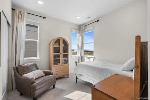 a bedroom with furniture and a large window