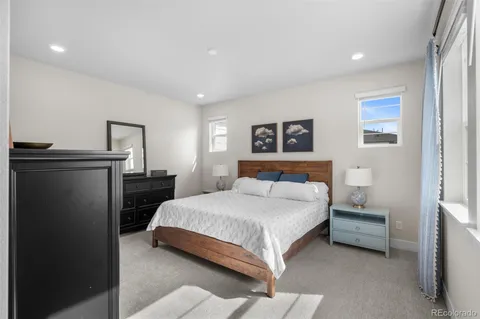 a bedroom with a bed and a lamp